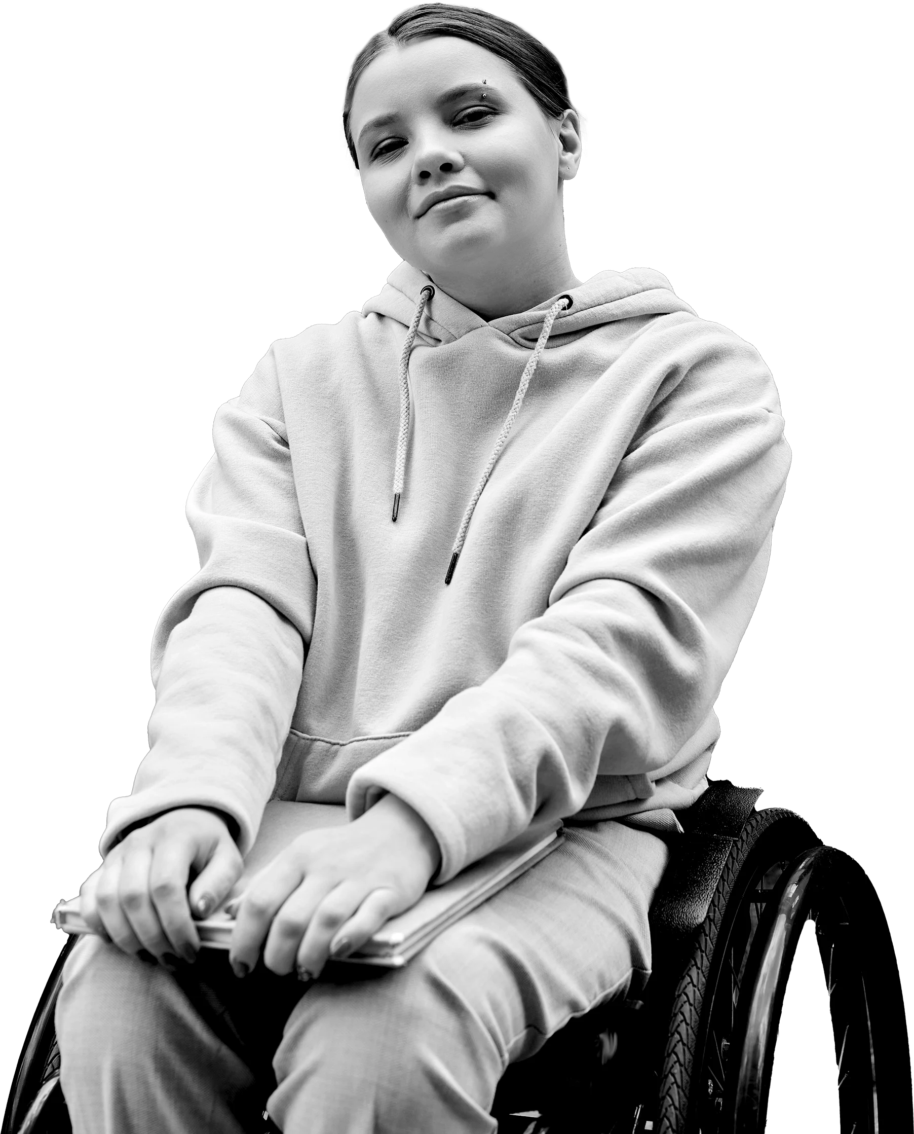 Person in wheelchair holding a book, smiling